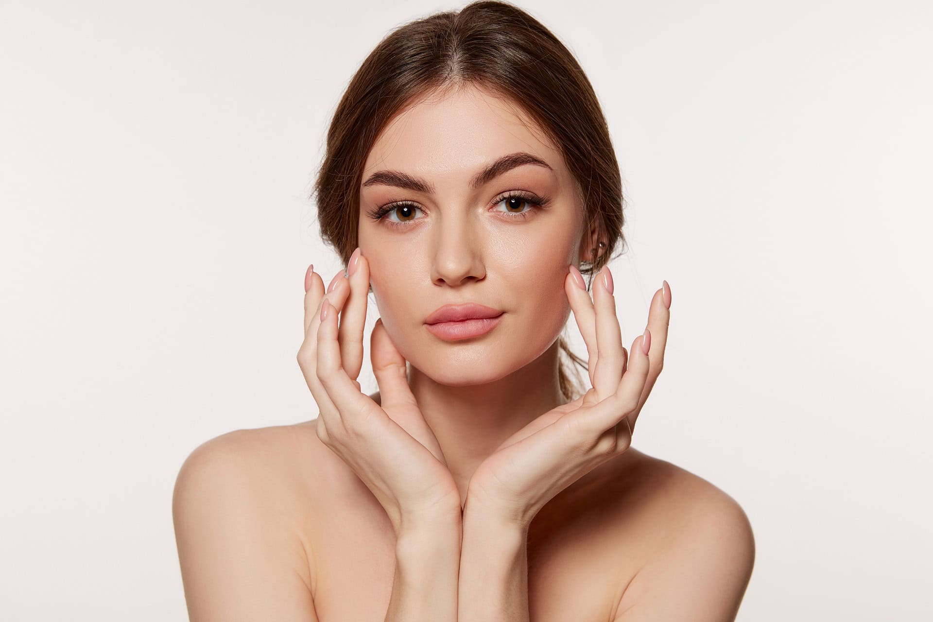 Portrait of young beautiful woman with perfect smooth skin isolated over white background. Perfect face, taking care after skin condition